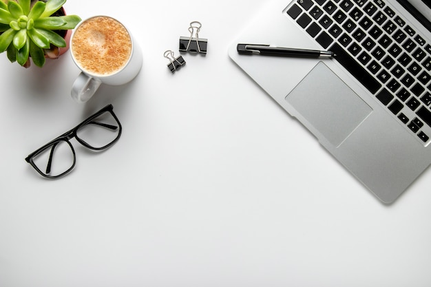 Flat lay desk with laptop and glasses