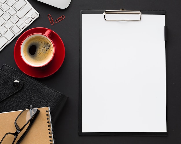 Flat lay of desk with paper and coffee cup