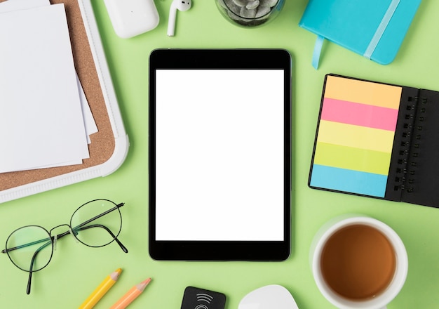 Flat lay of desk with tablet mock-up