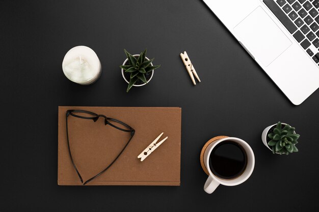 Flat lay of desktop with agenda and glasses on top