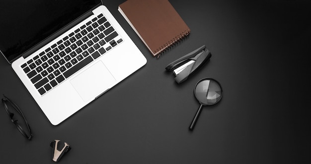 Free photo flat lay of desktop with laptop and magnifier