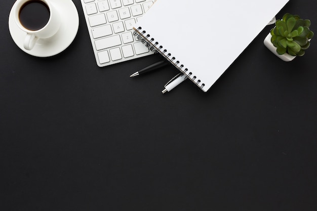 Flat lay of desktop with notebook and succulent