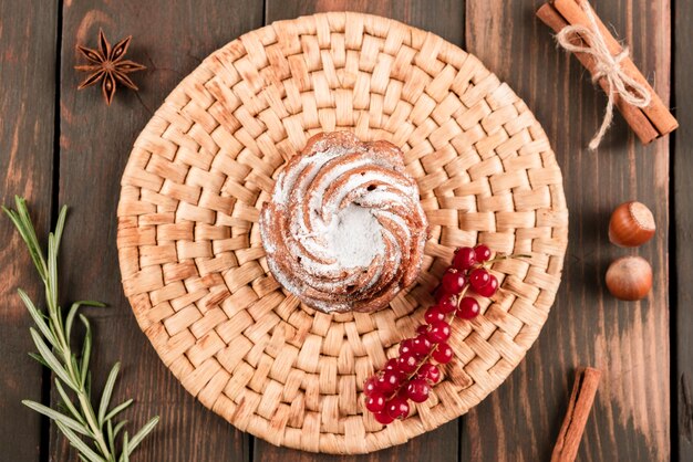 Flat lay of dessert with redcurrants and cinnamon