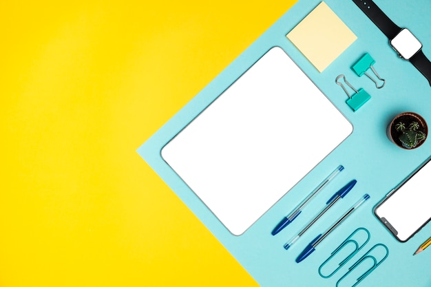 Flat lay devices with office supplies