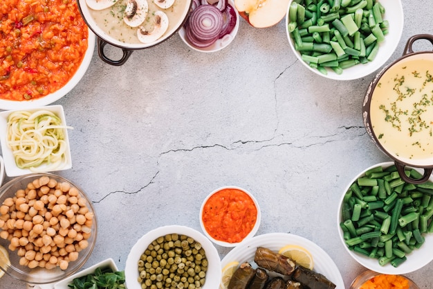 Flat lay of dishes with hummus and chickpeas with copy space