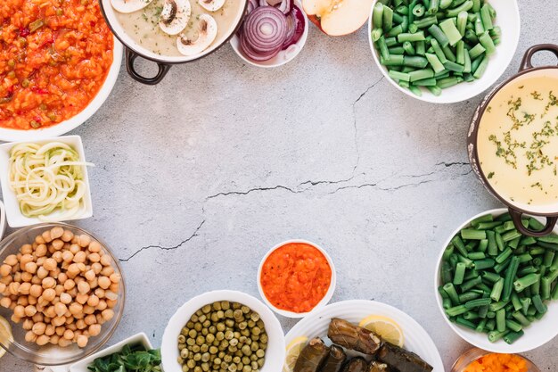 Flat lay of dishes with hummus and chickpeas with copy space