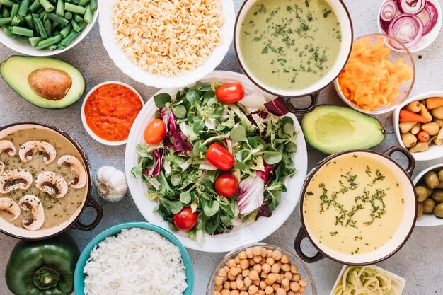 Flat lay of dishes with salad and soups