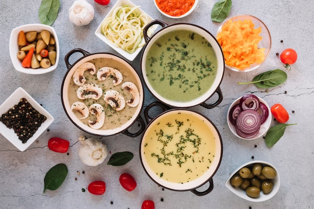 Flat lay of dishes with soups and garlic