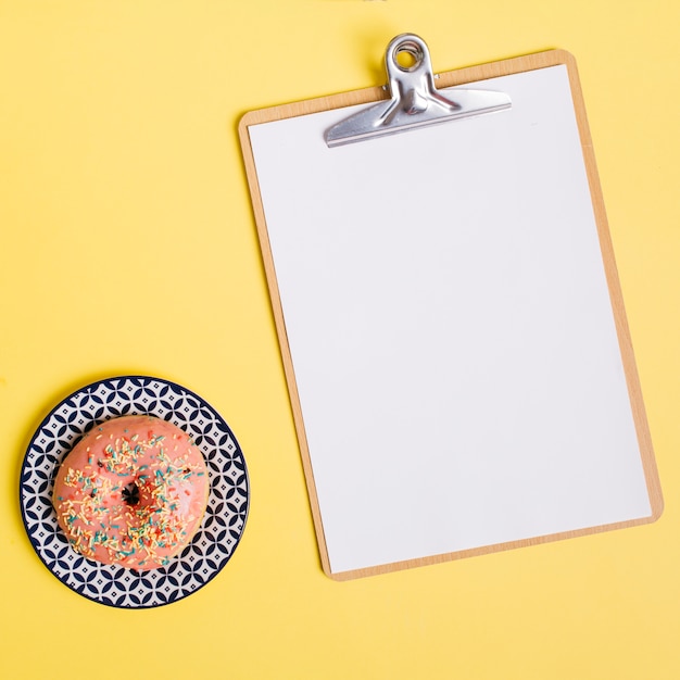 Flat lay donut composition with clipboard