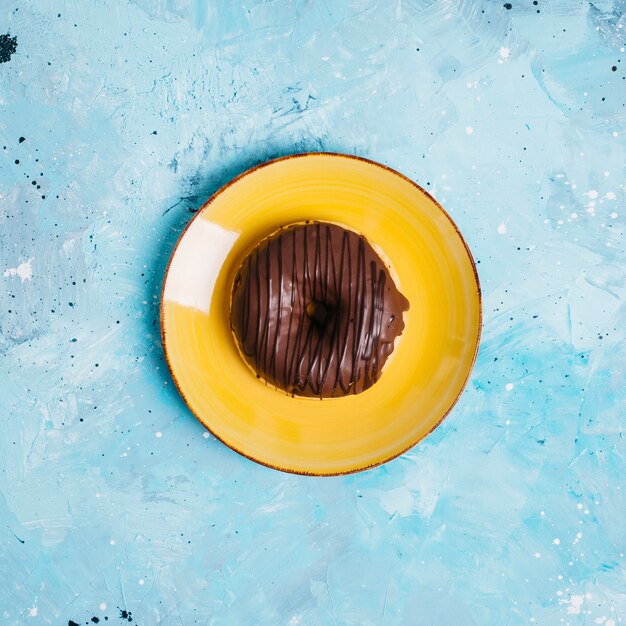 Flat lay of donut on plate