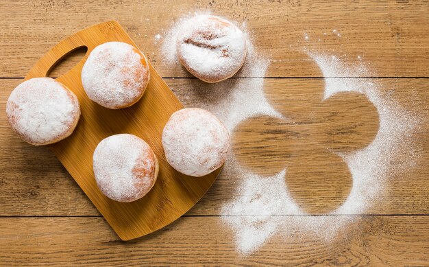 Flat lay of doughnuts with powdered sugar on top