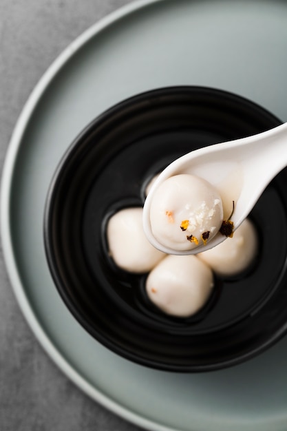 Flat lay of dumpling in spoon with spices
