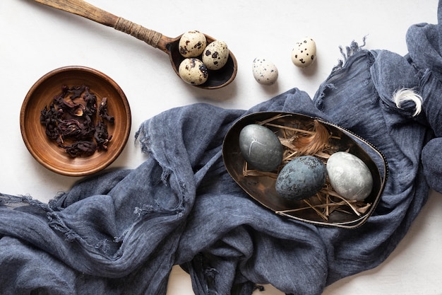 Flat lay of easter eggs with wooden spoon and textile