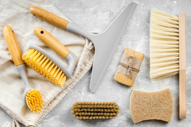 Flat lay of eco-friendly cleaning products with assortment of brushes