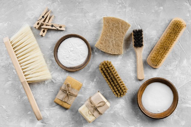 Flat lay of eco-friendly cleaning products with brushes and soaps