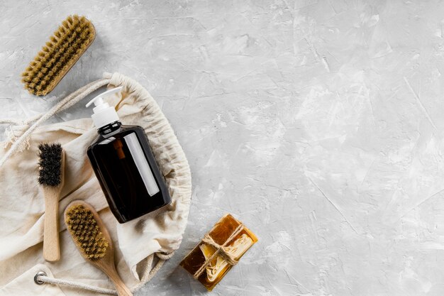 Flat lay of eco-friendly cleaning products with variety of brushes and copy space