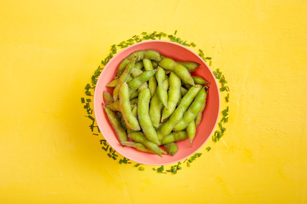 Flat lay edamame beans in bowl with fresh cut chives
