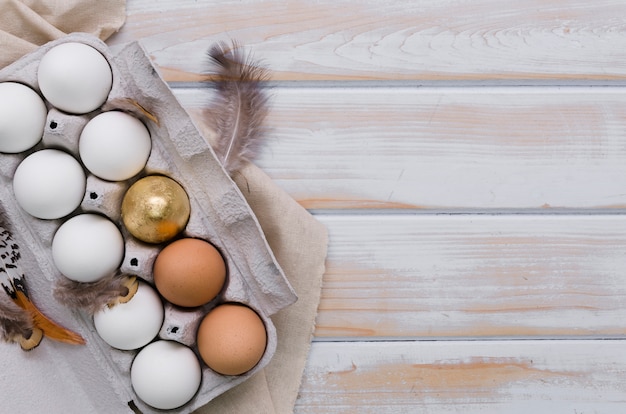 Flat lay of eggs for easter in carton with copy space