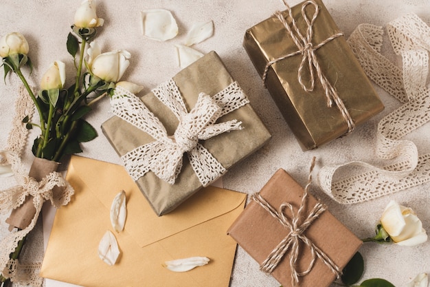 Flat lay of elegant presents with rose bouquet