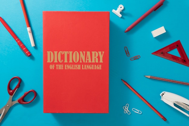 Free photo flat lay english dictionary and pencils