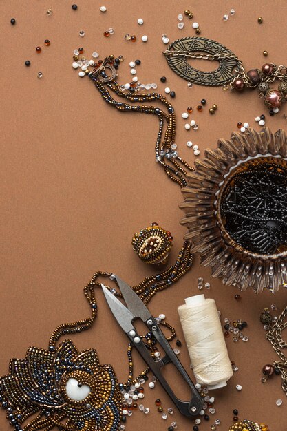 Flat lay of essentials for bead working with scissors and copy space