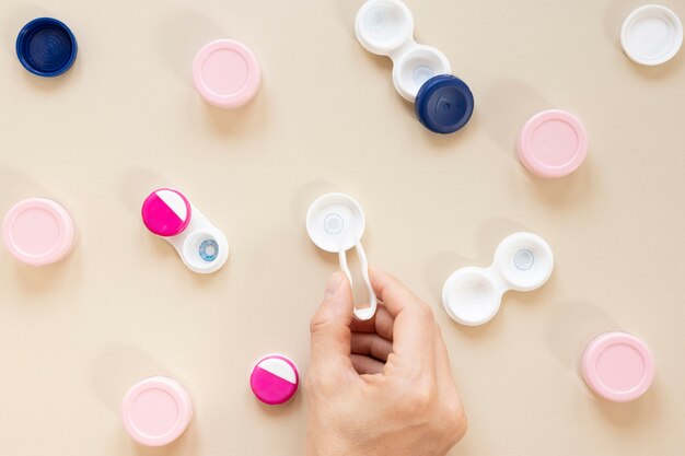 Flat lay eye care accessories on beige background