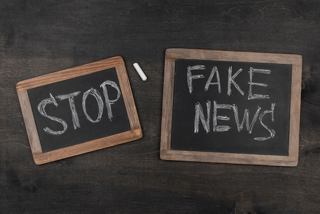 flat lay fake news blackboards