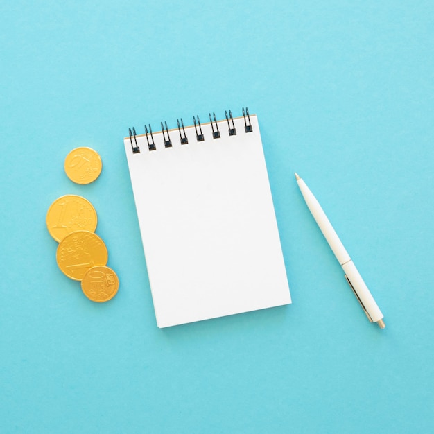 Flat lay finance elements arrangement with empty notepad