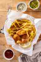 Free photo flat lay of fish and chips with sauces