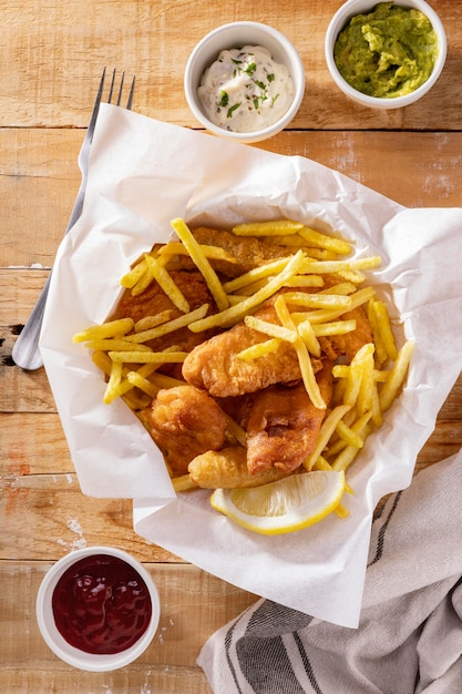 Flat lay of fish and chips with sauces
