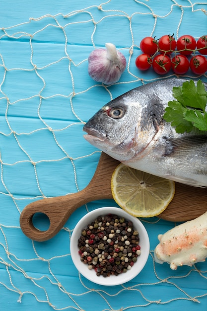 Flat lay fish and condiments for cooking