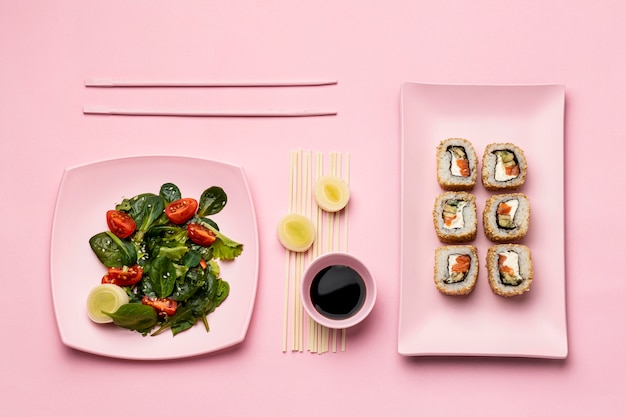 Free photo flat lay flexitarian diet with sushi and salad