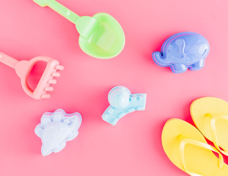 Free Photo flat lay of flip flops and toys