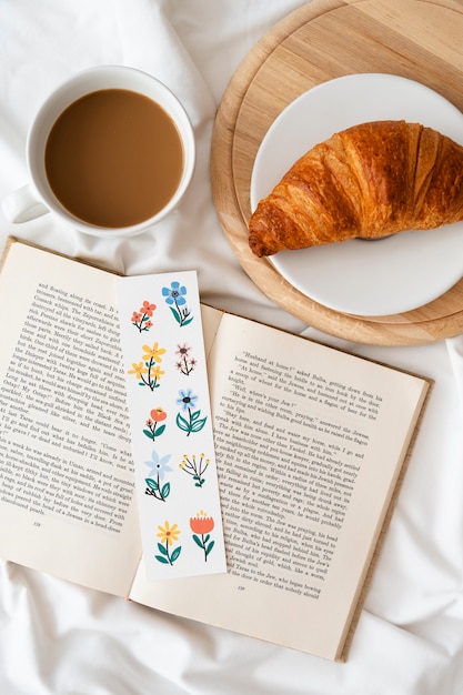 Free photo flat lay floral bookmark on book