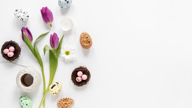 Flat lay flowers and basket with eggs