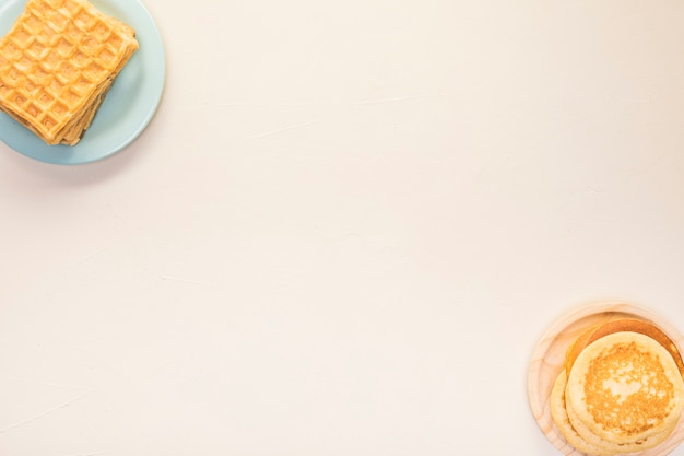 Flat lay food arrangement with pancakes and waffles