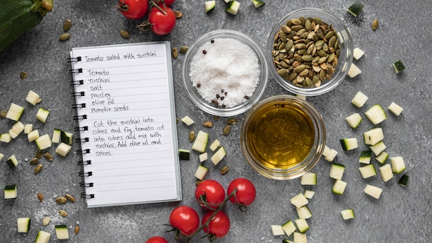 Flat lay of food ingredients with notebook