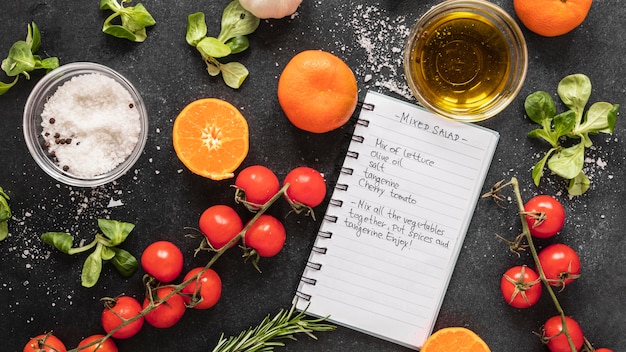 Flat lay of food ingredients with recipe and veggies