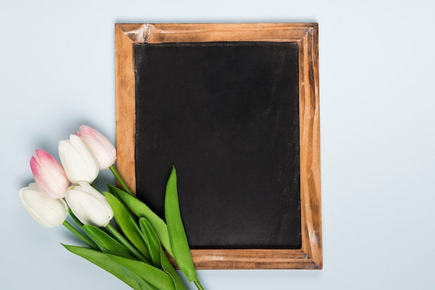 Flat lay frame beside tulips bouquet