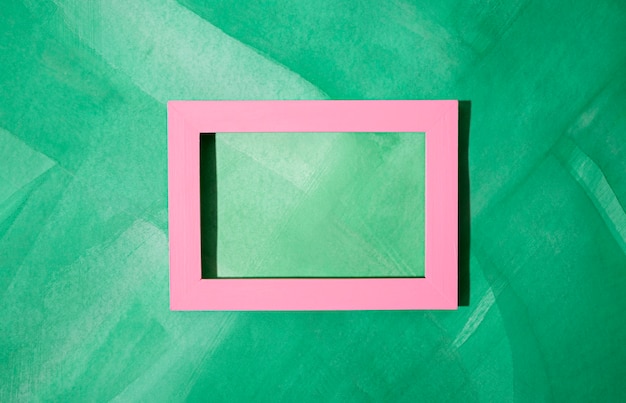 Flat lay frame on green painted background