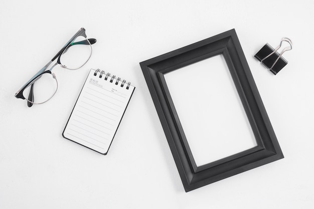 Free photo flat lay of frame and office elements