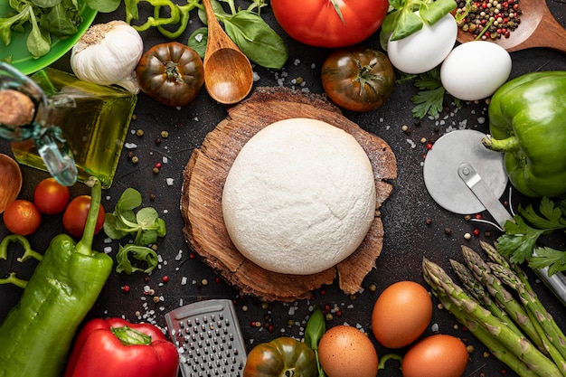 Free photo flat lay frame of vegetables and dough for pizza