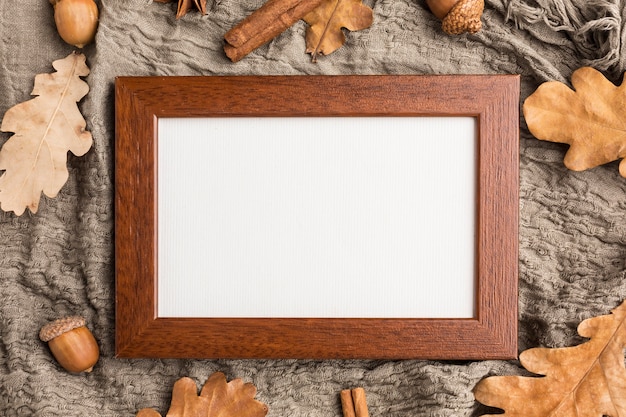 Flat lay of frame with acorns and autumn leaves