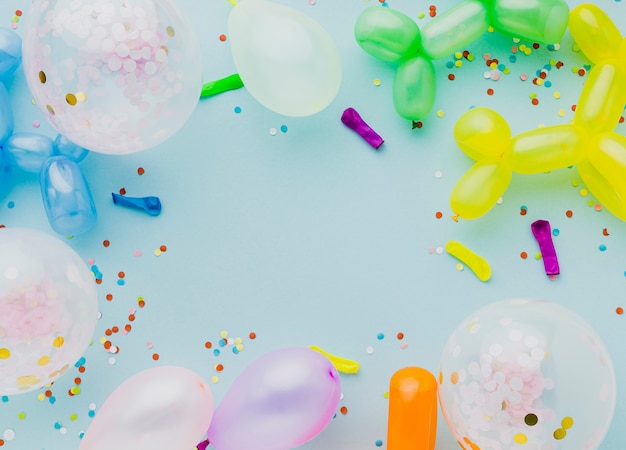 Flat lay frame with balloons and blue background