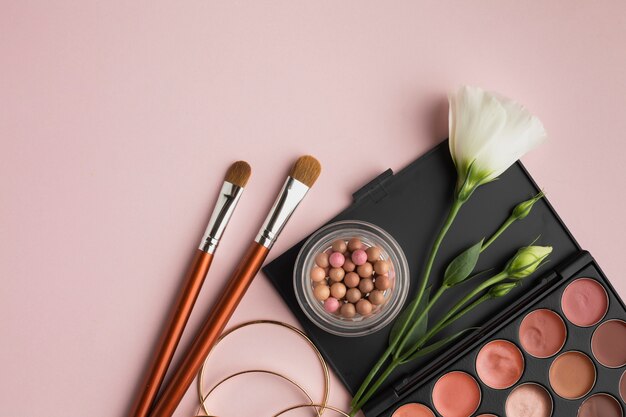 Flat lay frame with beauty palette and brushes