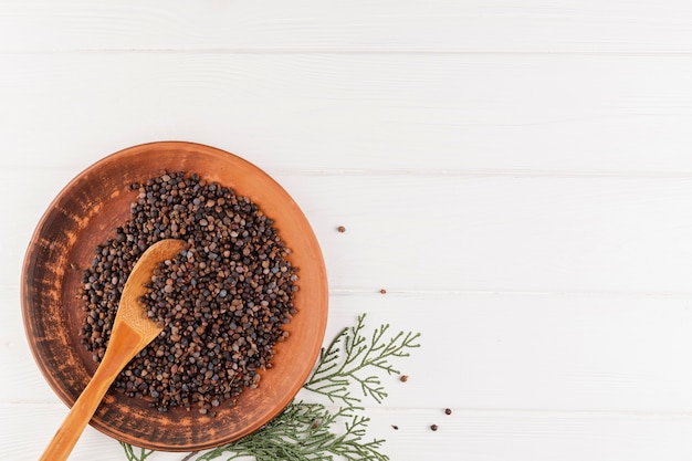 Flat lay frame with bowl of seeds and spoon