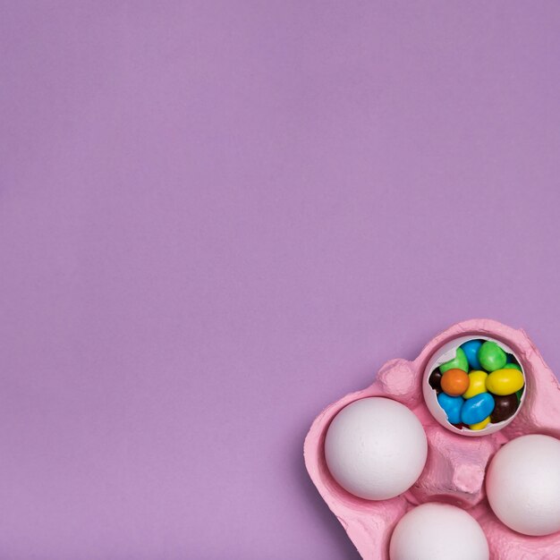 Flat lay frame with candy in egg shell