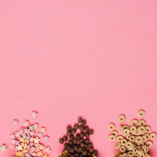 Flat lay frame with cereals on pink background