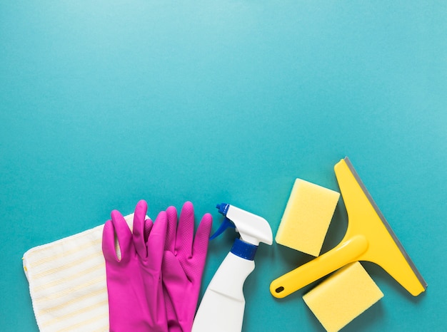 Flat lay frame with cleaning products and blue background