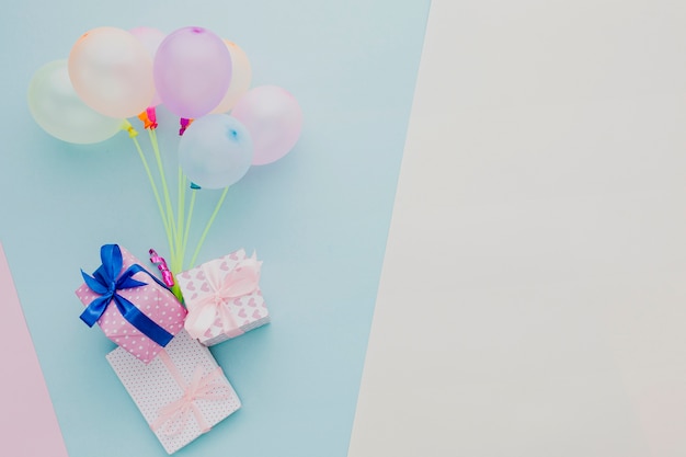 Flat lay frame with colorful balloons and gifts